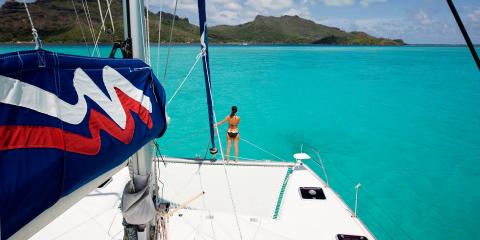 Woman on sailing catamaran trampoline