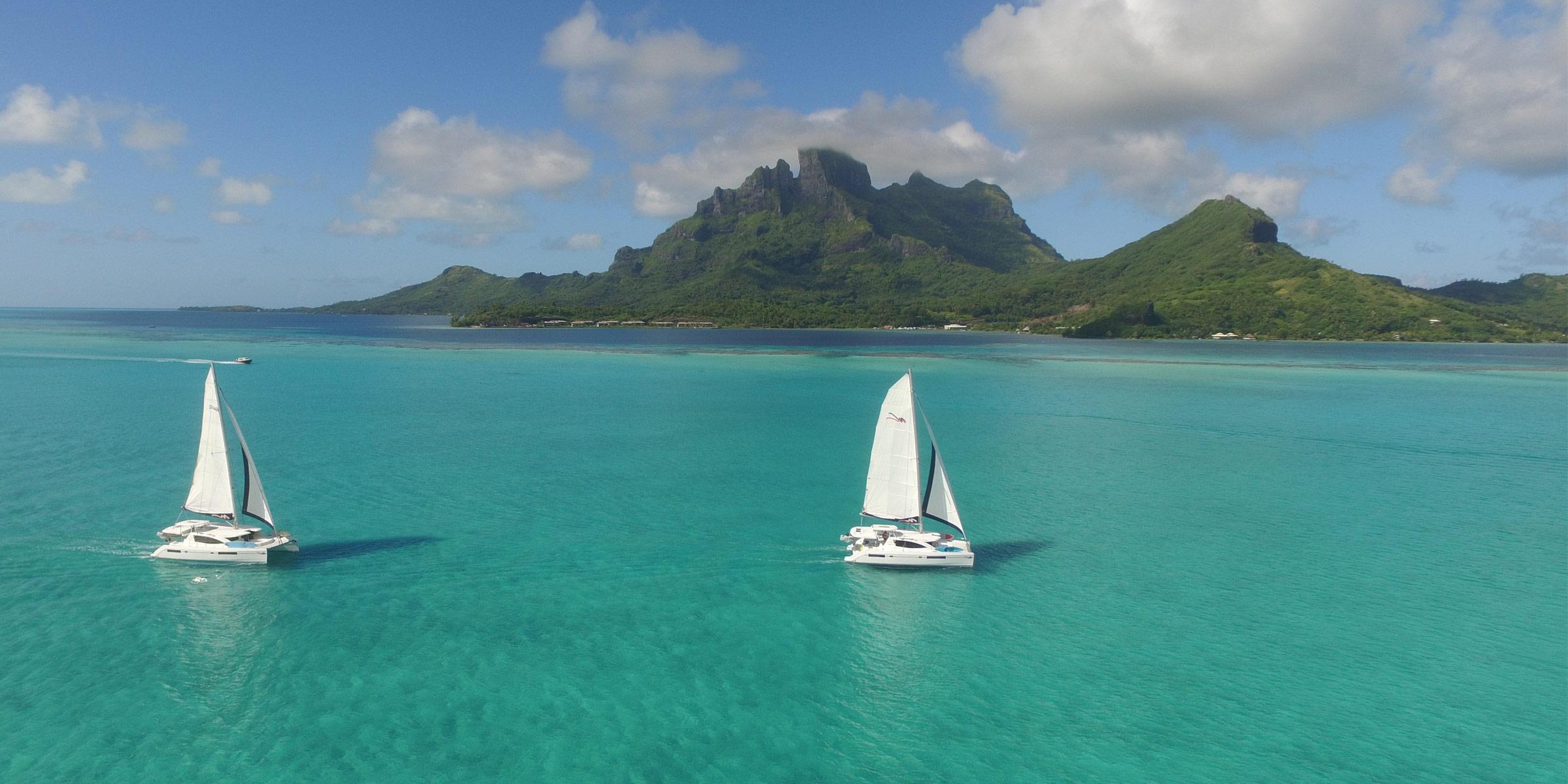 Two Moorings 4800 under sail with Bora Bora in the background